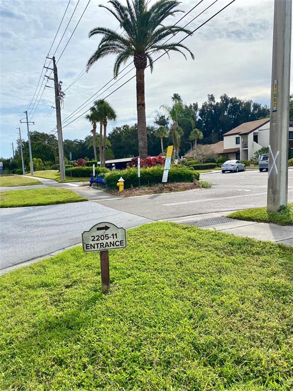 2209 Belleair Road, Unit C21 Clearwater, FL 33764 - Photo 3 of 23 a swimming pool with yard and outdoor seating