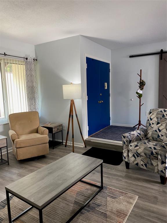 2209 Belleair Road, Unit C21 Clearwater, FL 33764 - Photo 4 of 23 a living room with furniture and wooden floor