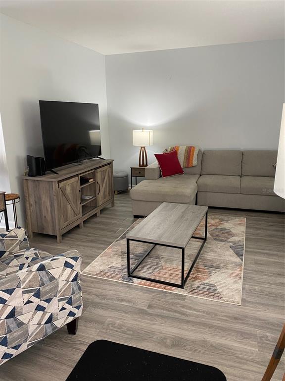 2209 Belleair Road, Unit C21 Clearwater, FL 33764 - Photo 5 of 23 a living room with furniture and a flat screen tv
