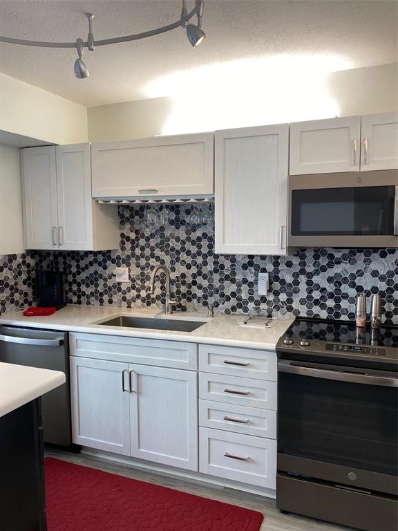 2209 Belleair Road, Unit C21 Clearwater, FL 33764 - Photo 8 of 23 a kitchen with granite countertop a stove and a sink