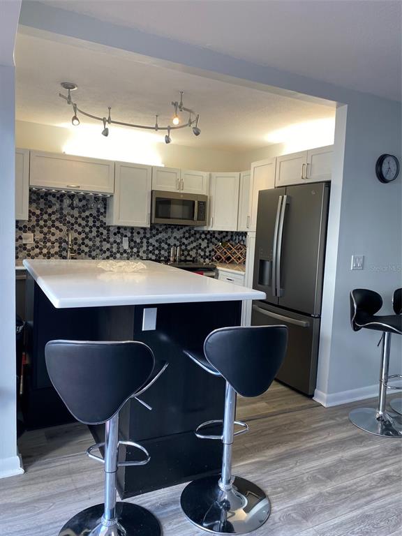 2209 Belleair Road, Unit C21 Clearwater, FL 33764 - Photo 10 of 23 a kitchen with a dining table and chairs