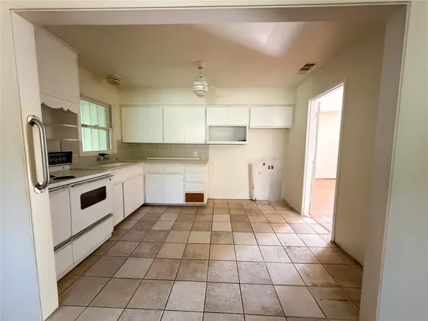 a kitchen with a stove a sink and a refrigerator