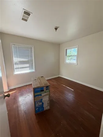 a room with wooden floor and window