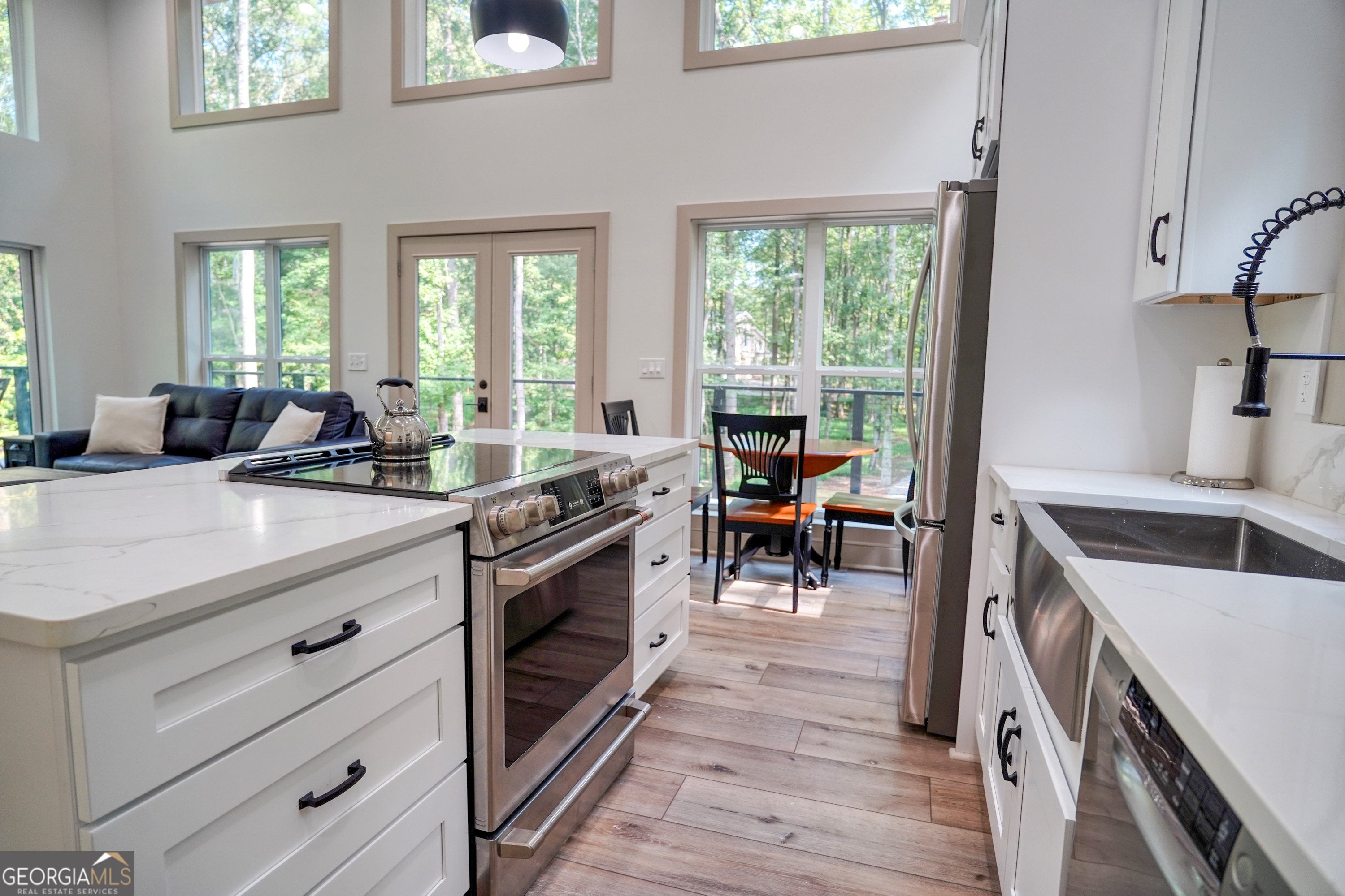 440 Palmetto Road Tyrone, GA 30290 - Photo 11 of 32 a kitchen with stainless steel appliances white cabinets and wooden floor