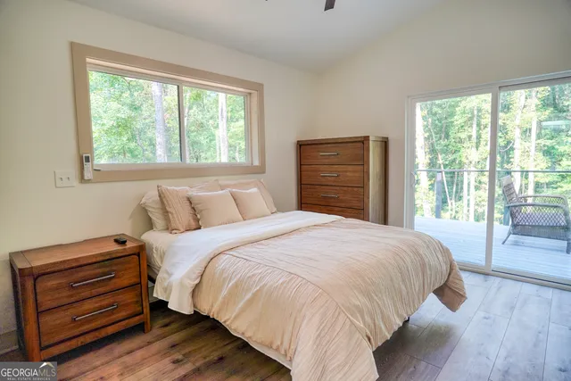 a bedroom with a bed next to a window