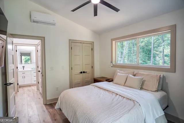 a bedroom with a bed and a wooden floor