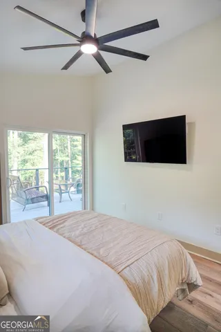 a bedroom with a bed and a flat tv screen