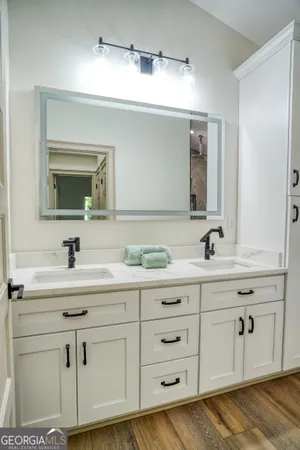 a bathroom with a sink vanity and mirror