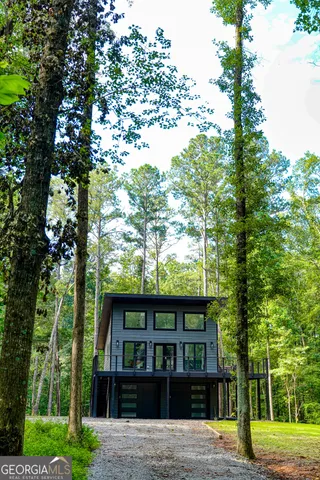 a view of a house with a tree in front of it