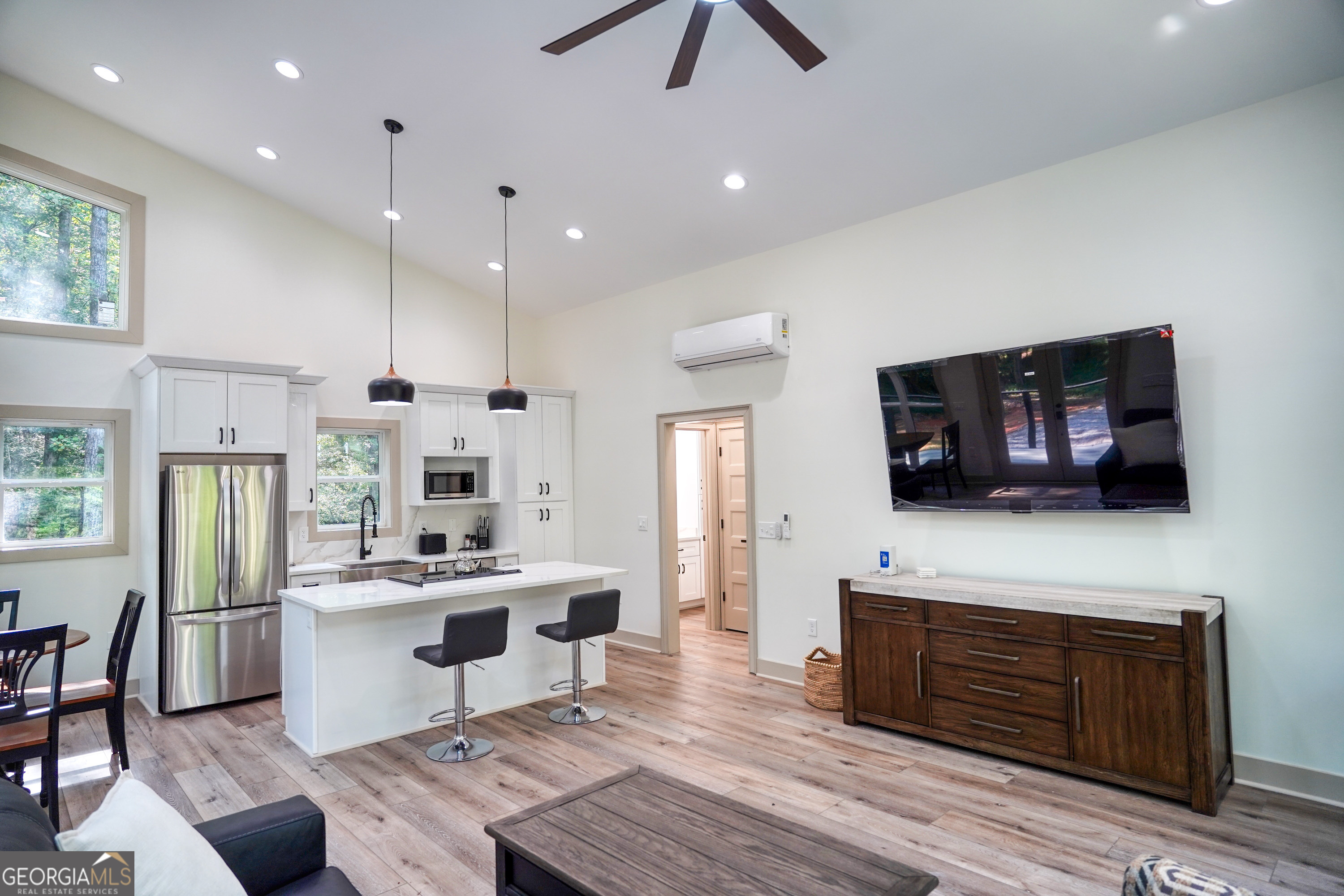 440 Palmetto Road Tyrone, GA 30290 - Photo 6 of 32 a living room with stainless steel appliances furniture a fireplace a flat screen tv and a kitchen view
