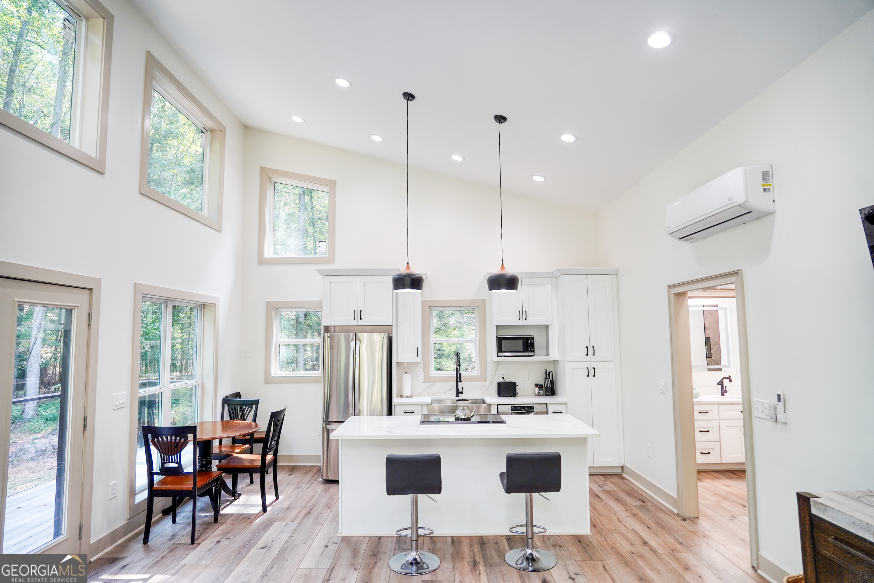 440 Palmetto Road Tyrone, GA 30290 - Photo 7 of 32 a view of a kitchen with kitchen island stainless steel appliances a table and chairs