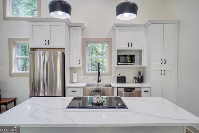 a living room with hard wood floors and a sink