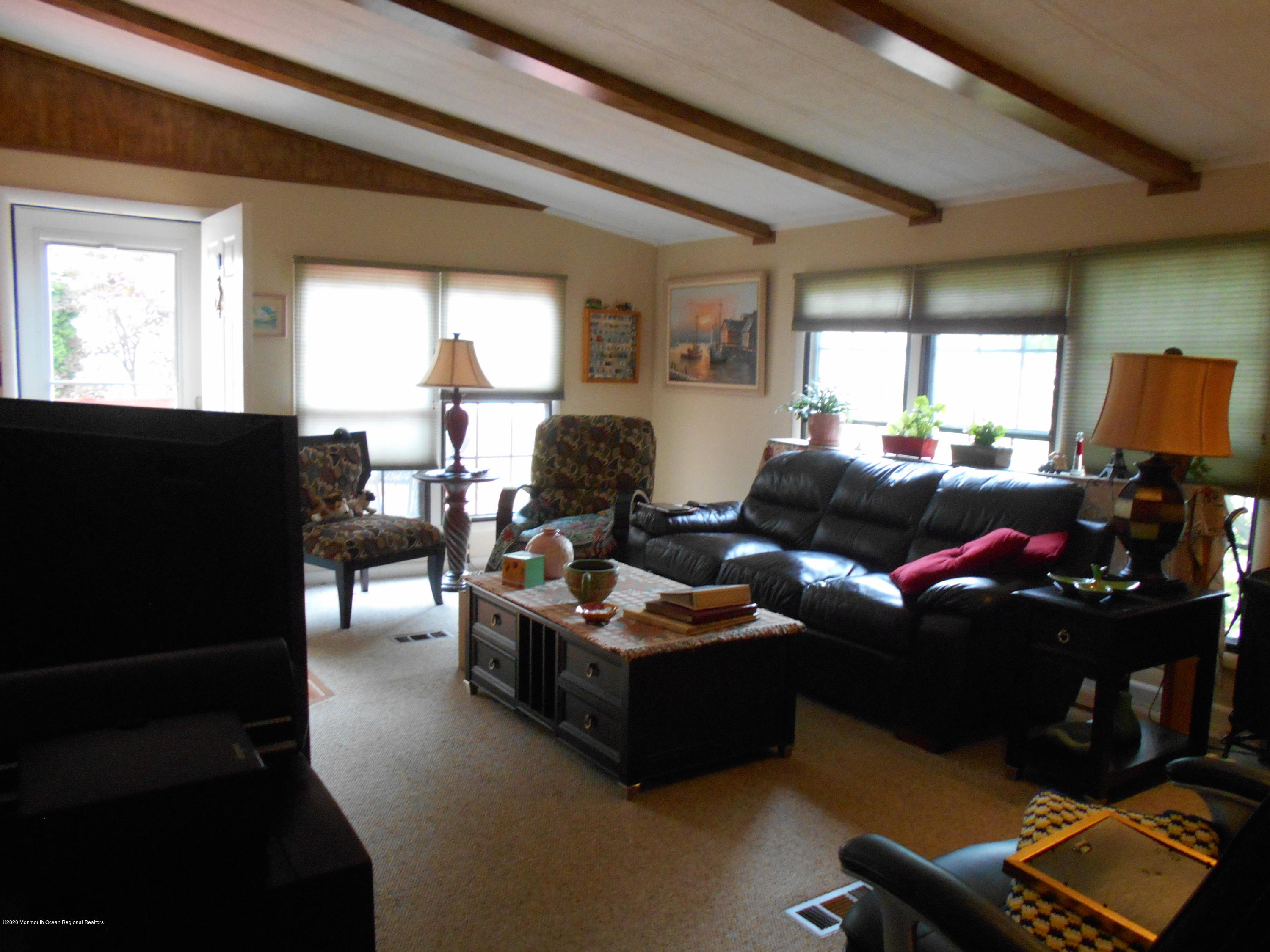 484 Rosalind Road Freehold, NJ 07728 - Photo 14 of 27 a living room with furniture window and a flat screen tv