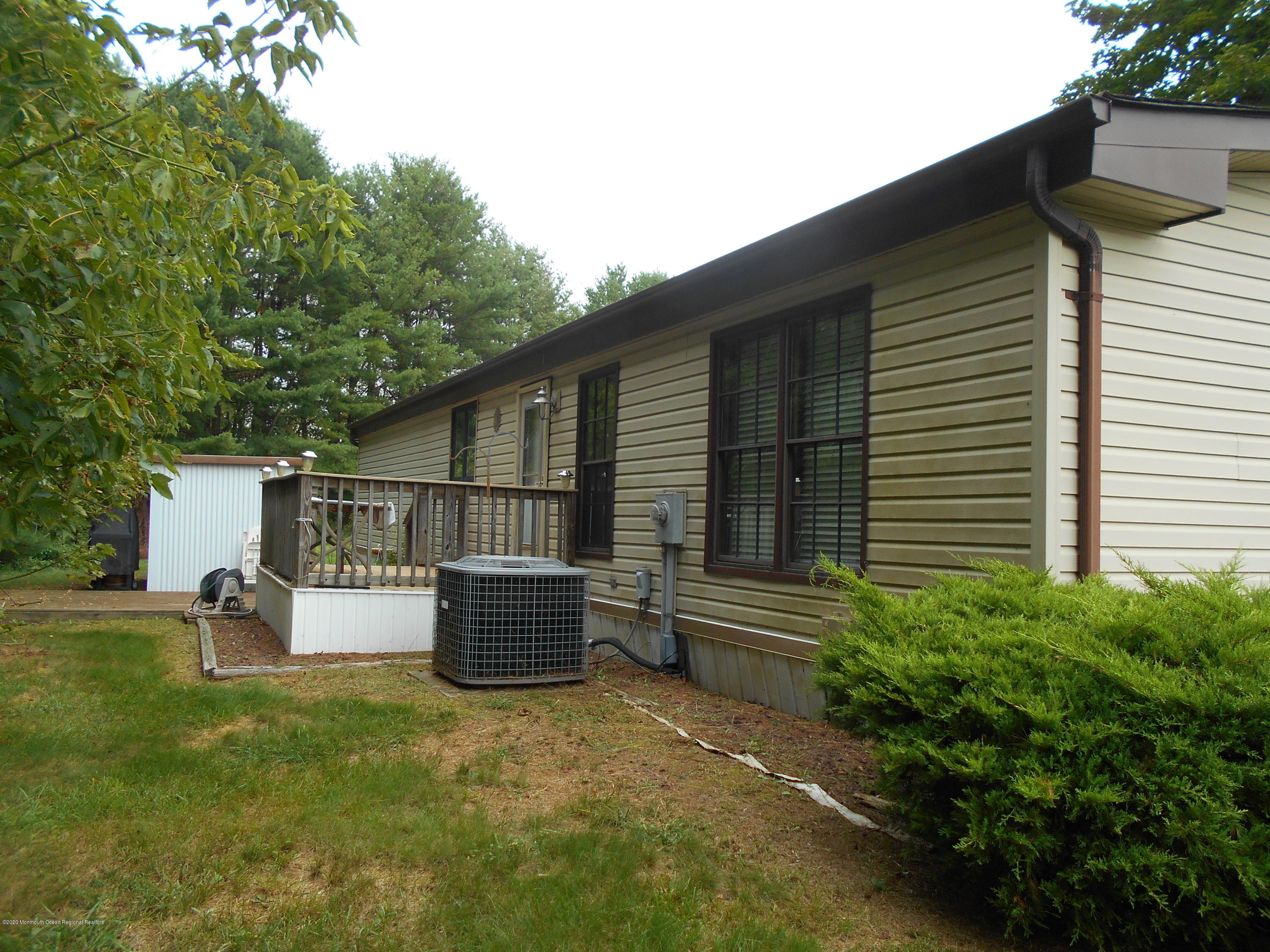 484 Rosalind Road Freehold, NJ 07728 - Photo 22 of 27 a backyard of a house with barbeque oven and plants