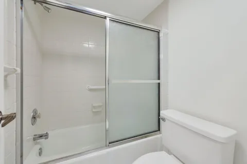 a bathroom with a shower and a toilet