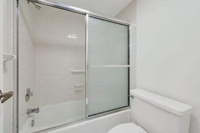 a bathroom with a shower and a toilet