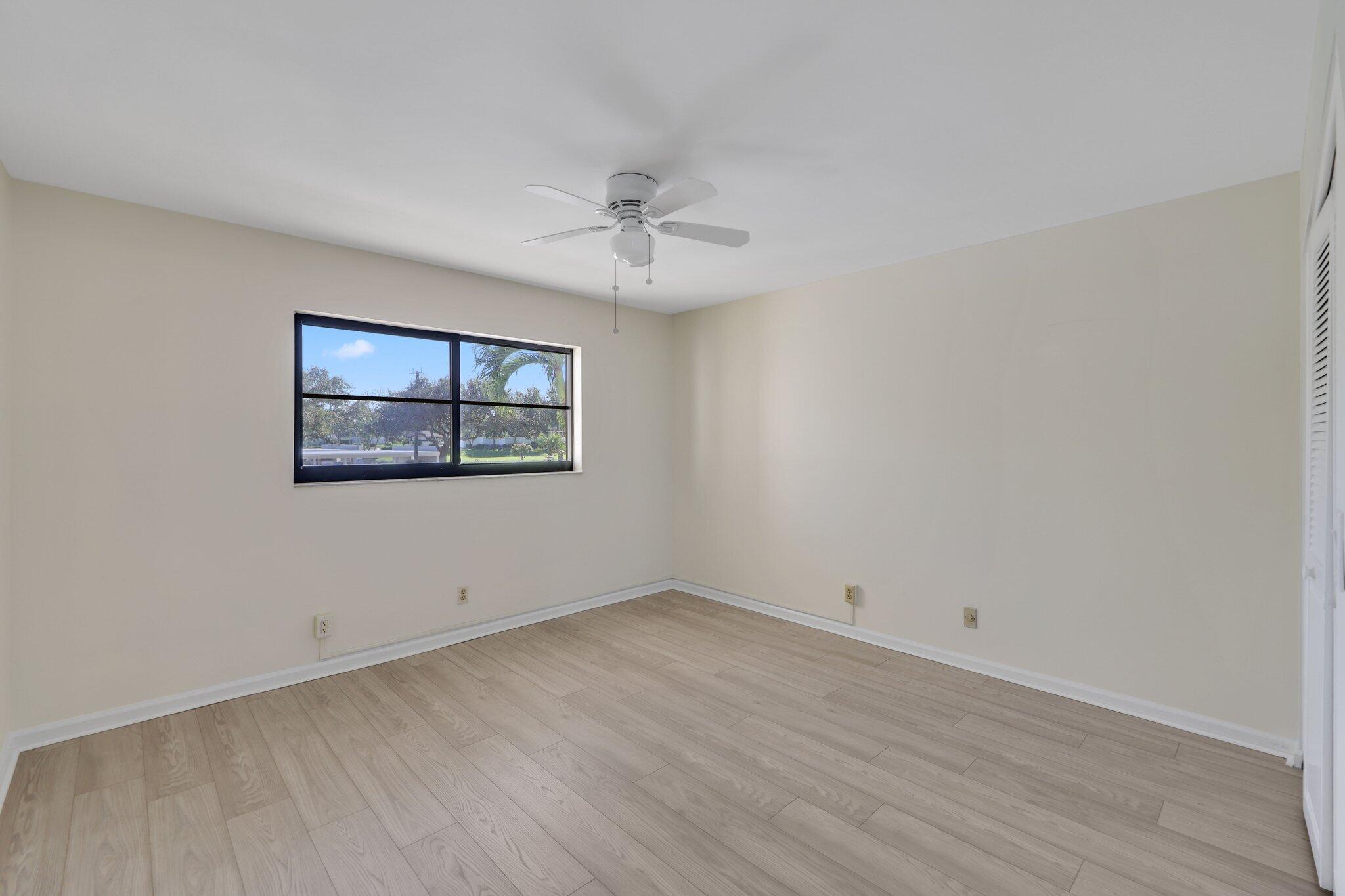 200 Intracoastal Place, Unit 206 Jupiter, FL 33469 - Photo 16 of 35 wooden floor in an empty room with a window