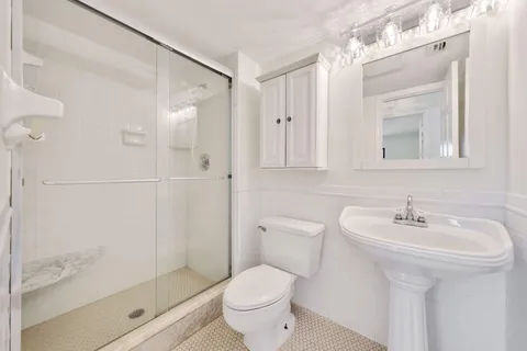 a bathroom with a sink toilet and shower