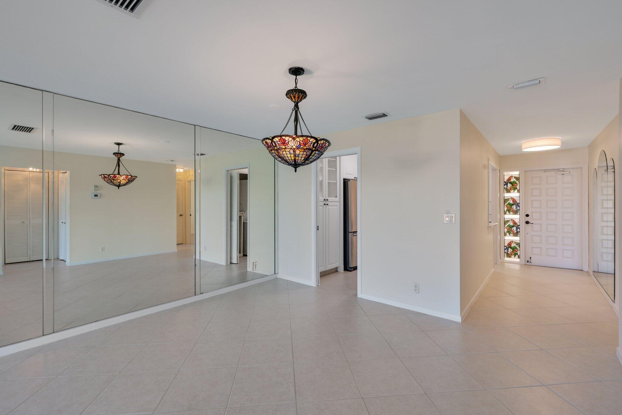 200 Intracoastal Place, Unit 206 Jupiter, FL 33469 - Photo 23 of 35 a view of a hallway with a chandelier