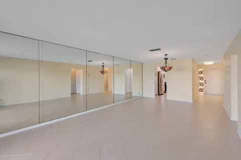 a view of a room with a ceiling fan and window