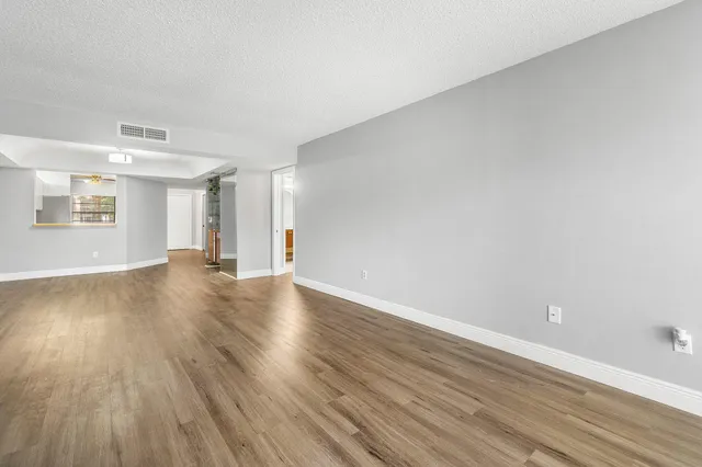 a view of wooden floor and windows in a room