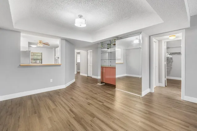 a view of a room with wooden floor and window