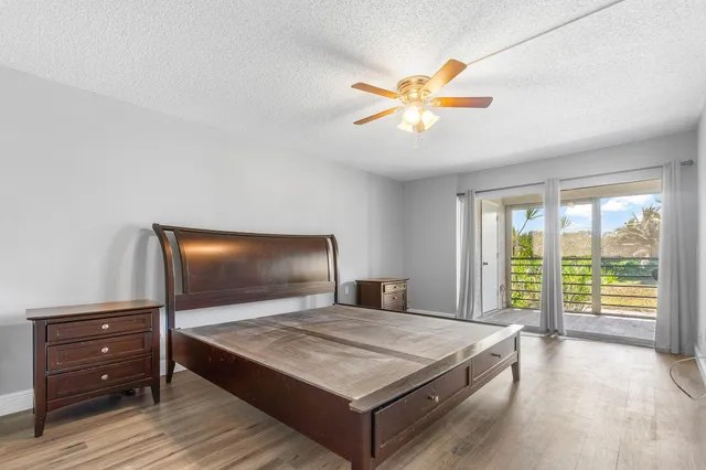 a bedroom with a bed and a flat tv screen on dresser