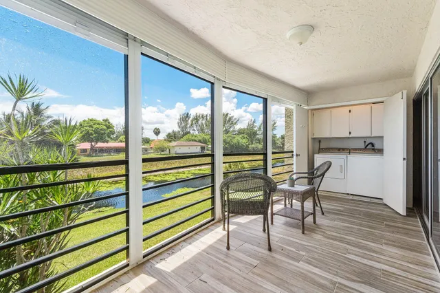 a dining room with furniture and a floor to ceiling window