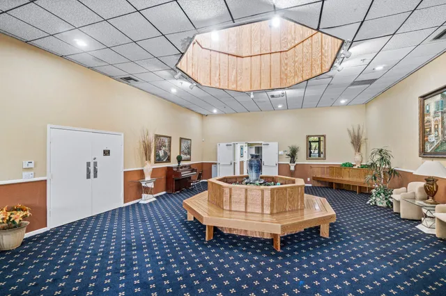 a living room with furniture a table and a chandelier