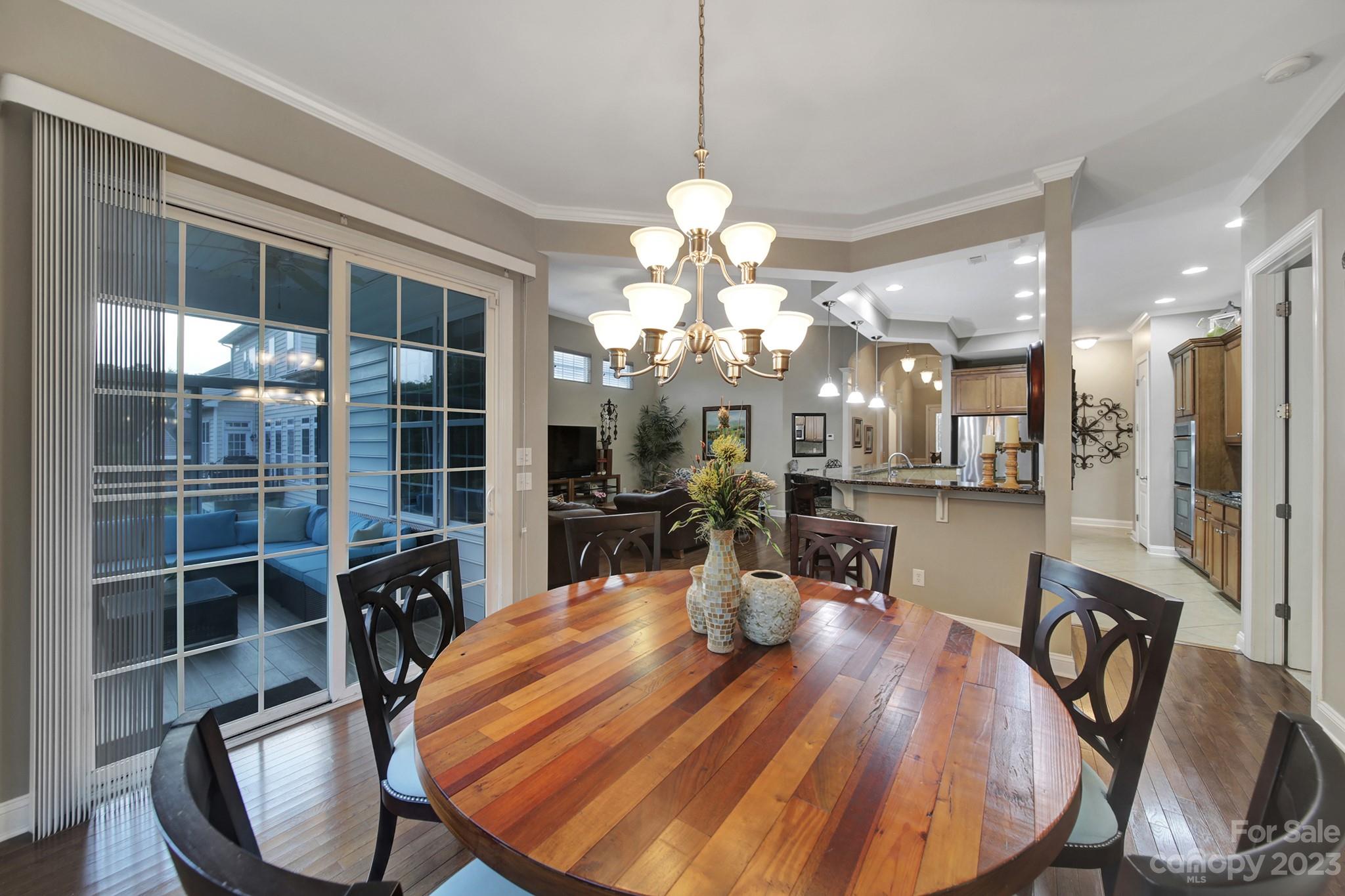 818 Treasure Court Fort Mill, SC 29708 - Photo 11 of 47 a view of a dining room with furniture and wooden floor