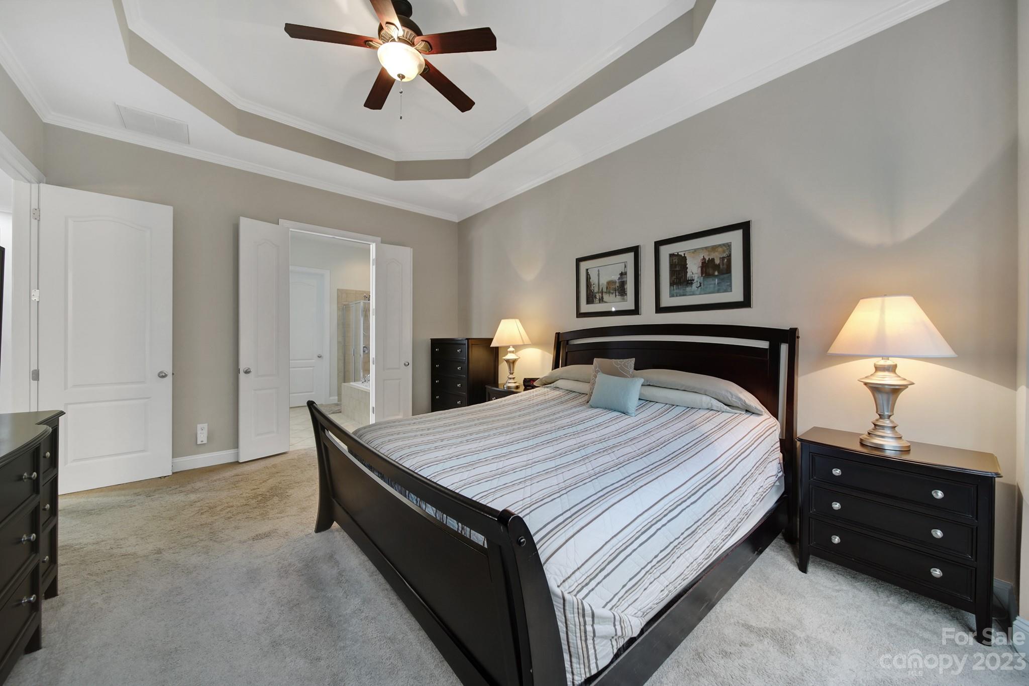 818 Treasure Court Fort Mill, SC 29708 - Photo 13 of 47 a bed room with a bed and a chandelier