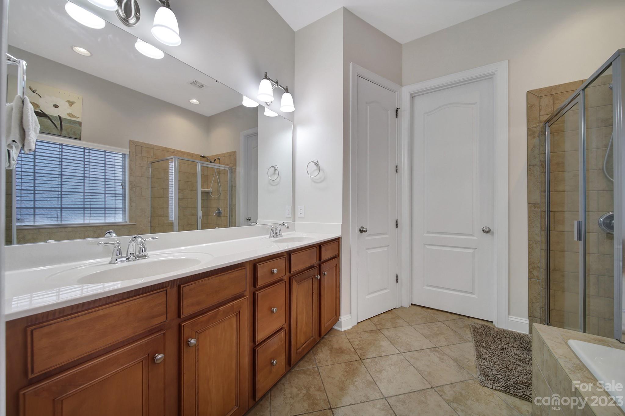 818 Treasure Court Fort Mill, SC 29708 - Photo 14 of 47 a spacious bathroom with a double vanity sink mirror and double