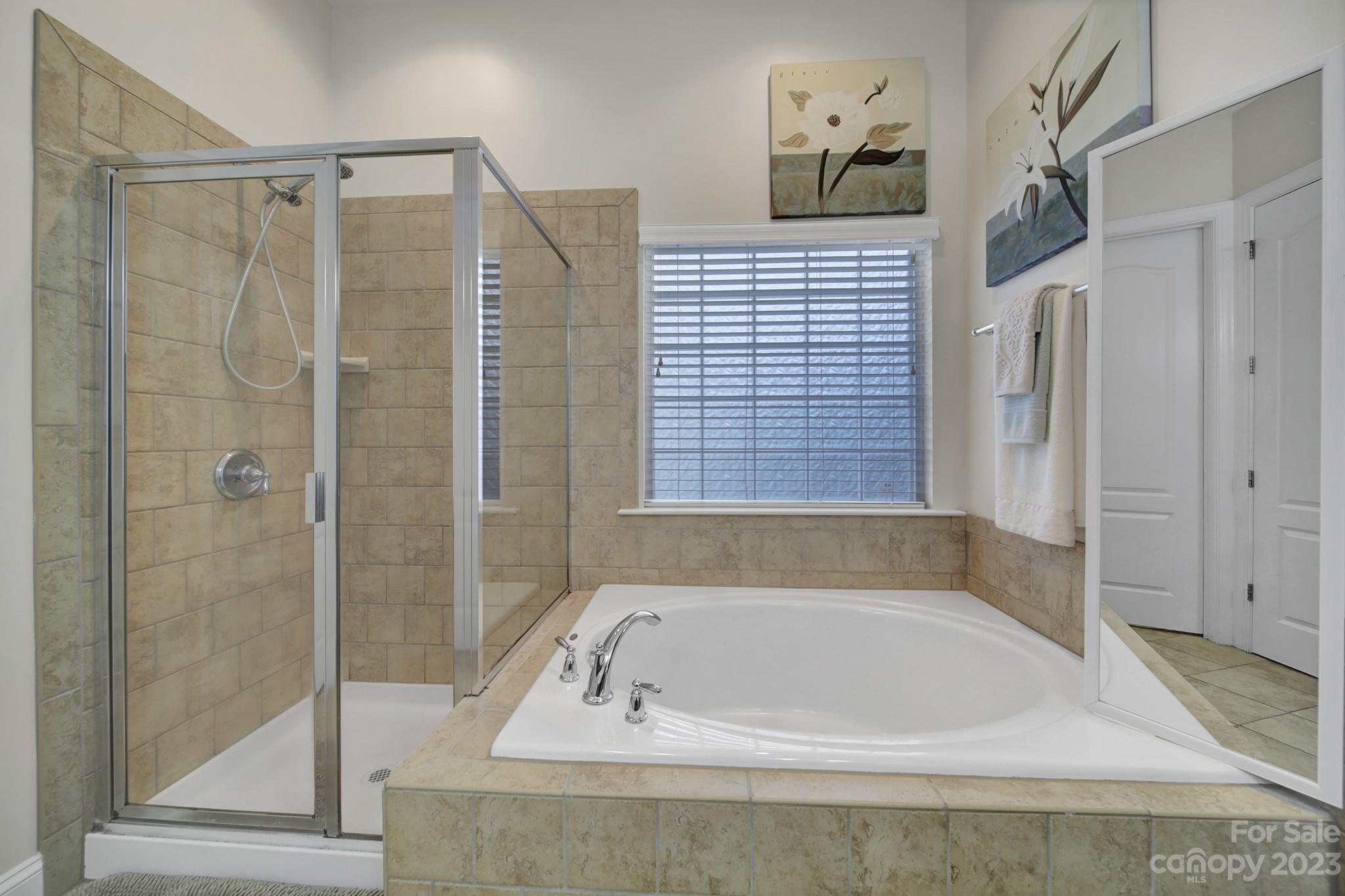 818 Treasure Court Fort Mill, SC 29708 - Photo 15 of 47 a bathroom with a bath tub and a shower