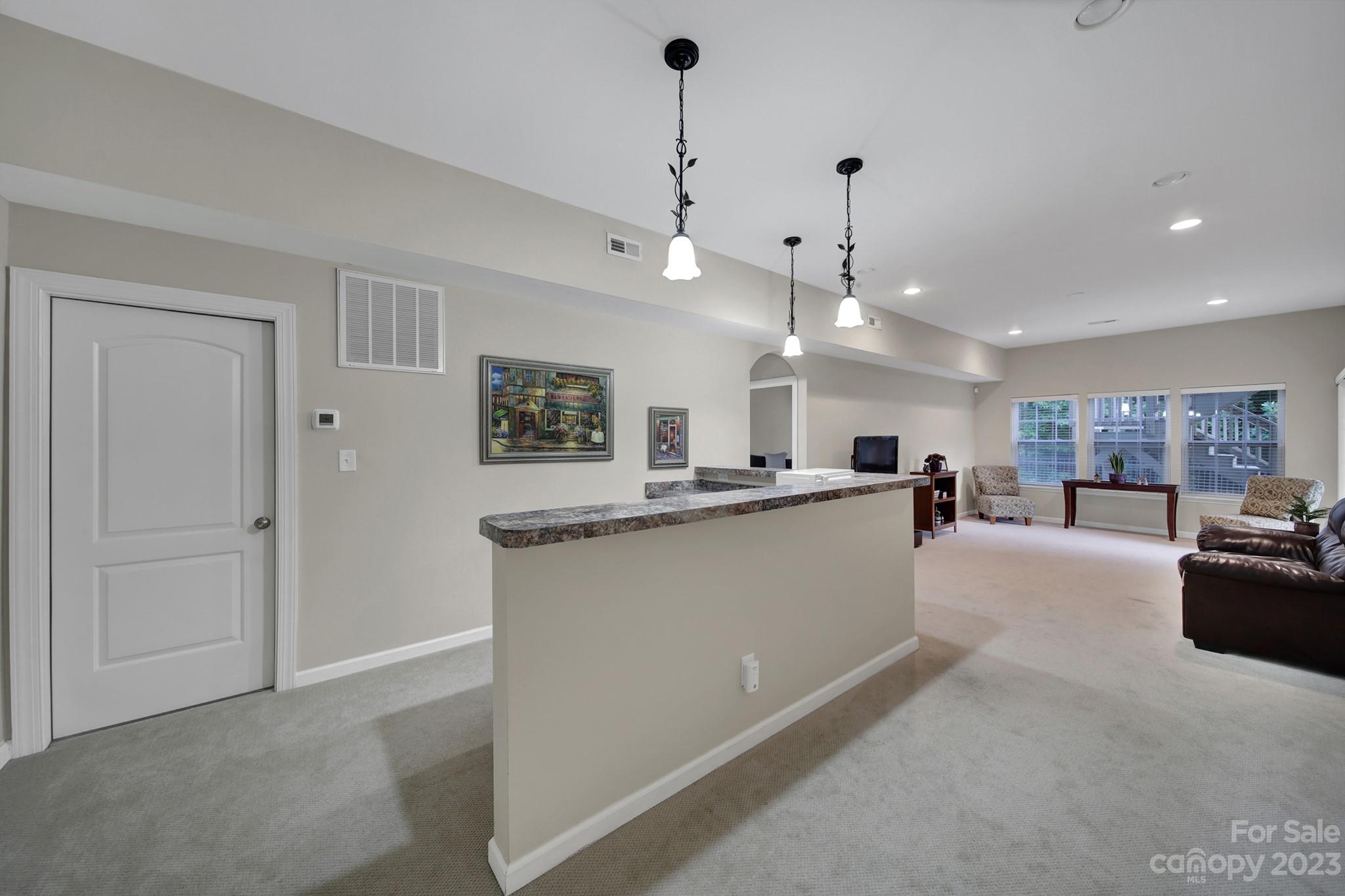 818 Treasure Court Fort Mill, SC 29708 - Photo 24 of 47 a large kitchen with kitchen island a large counter space a sink stainless steel appliances and cabinets