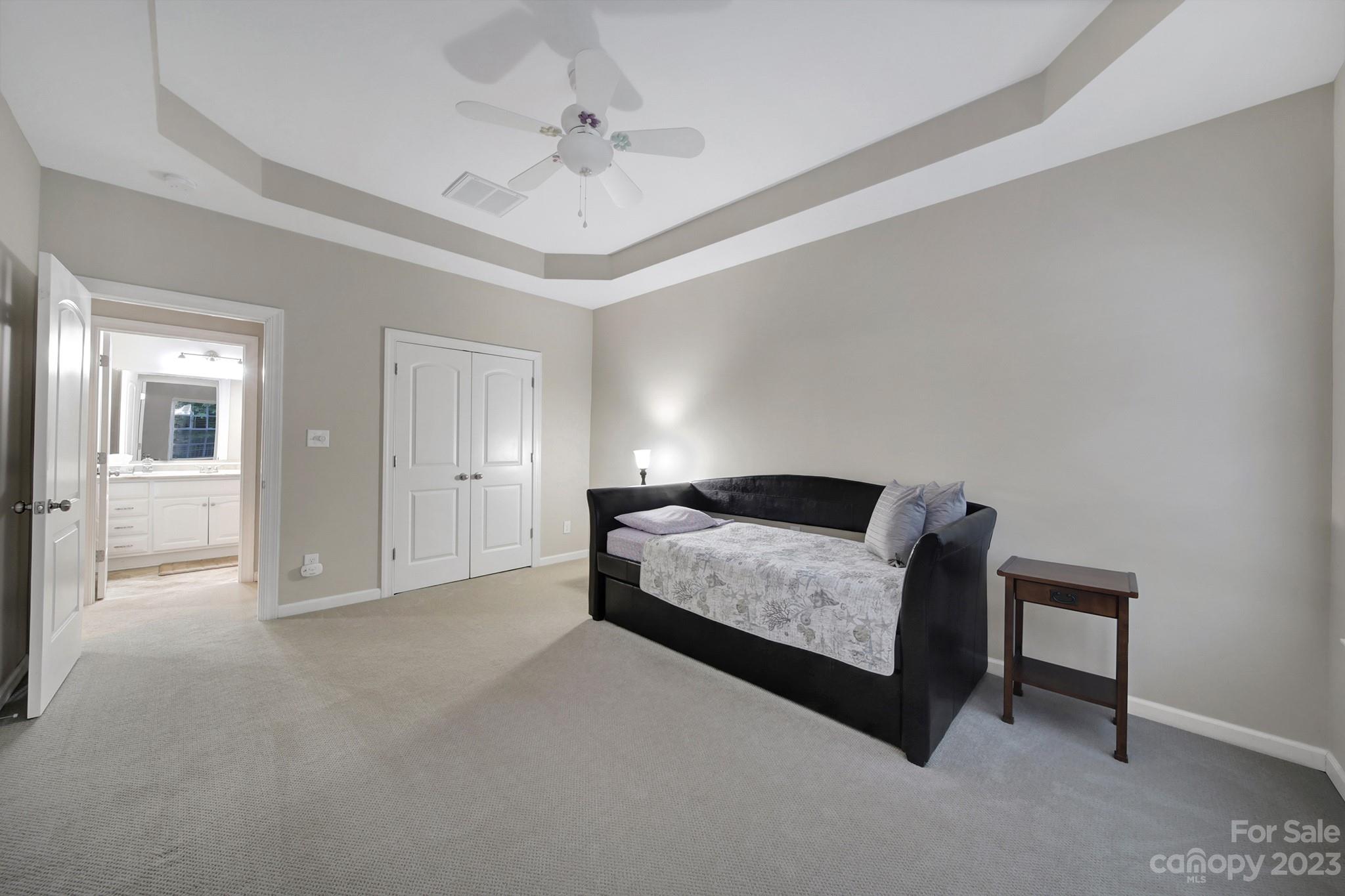 818 Treasure Court Fort Mill, SC 29708 - Photo 30 of 47 a spacious bedroom with a bed and a chandelier