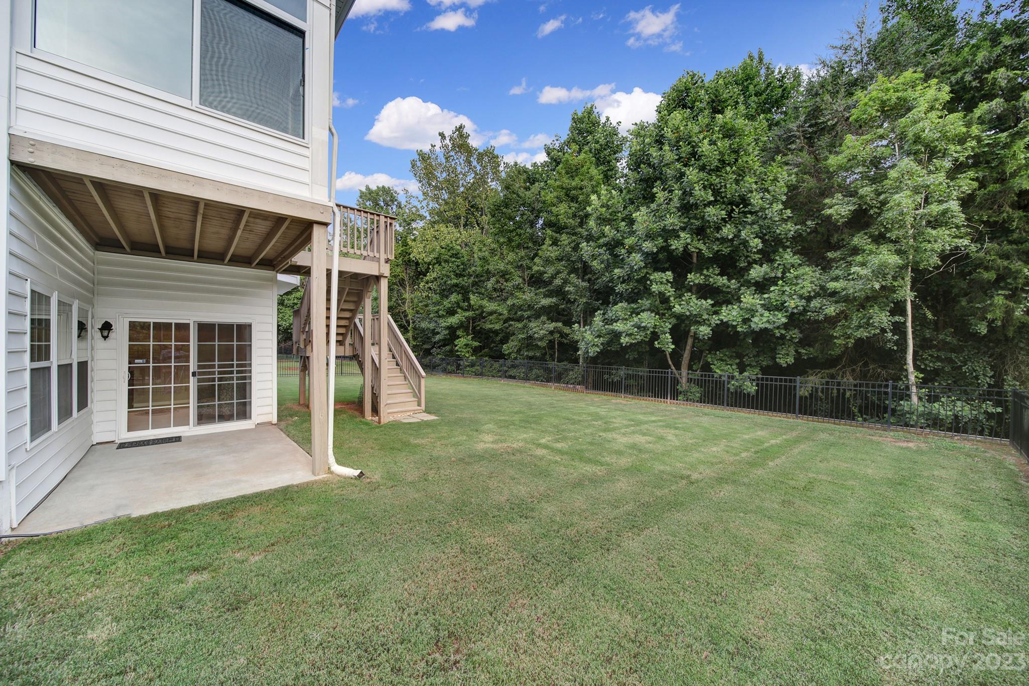 818 Treasure Court Fort Mill, SC 29708 - Photo 40 of 47 a view of a backyard with plants and large tree