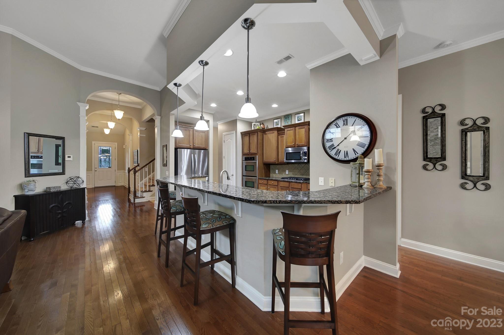 818 Treasure Court Fort Mill, SC 29708 - Photo 7 of 47 an open kitchen with a dining table and chairs