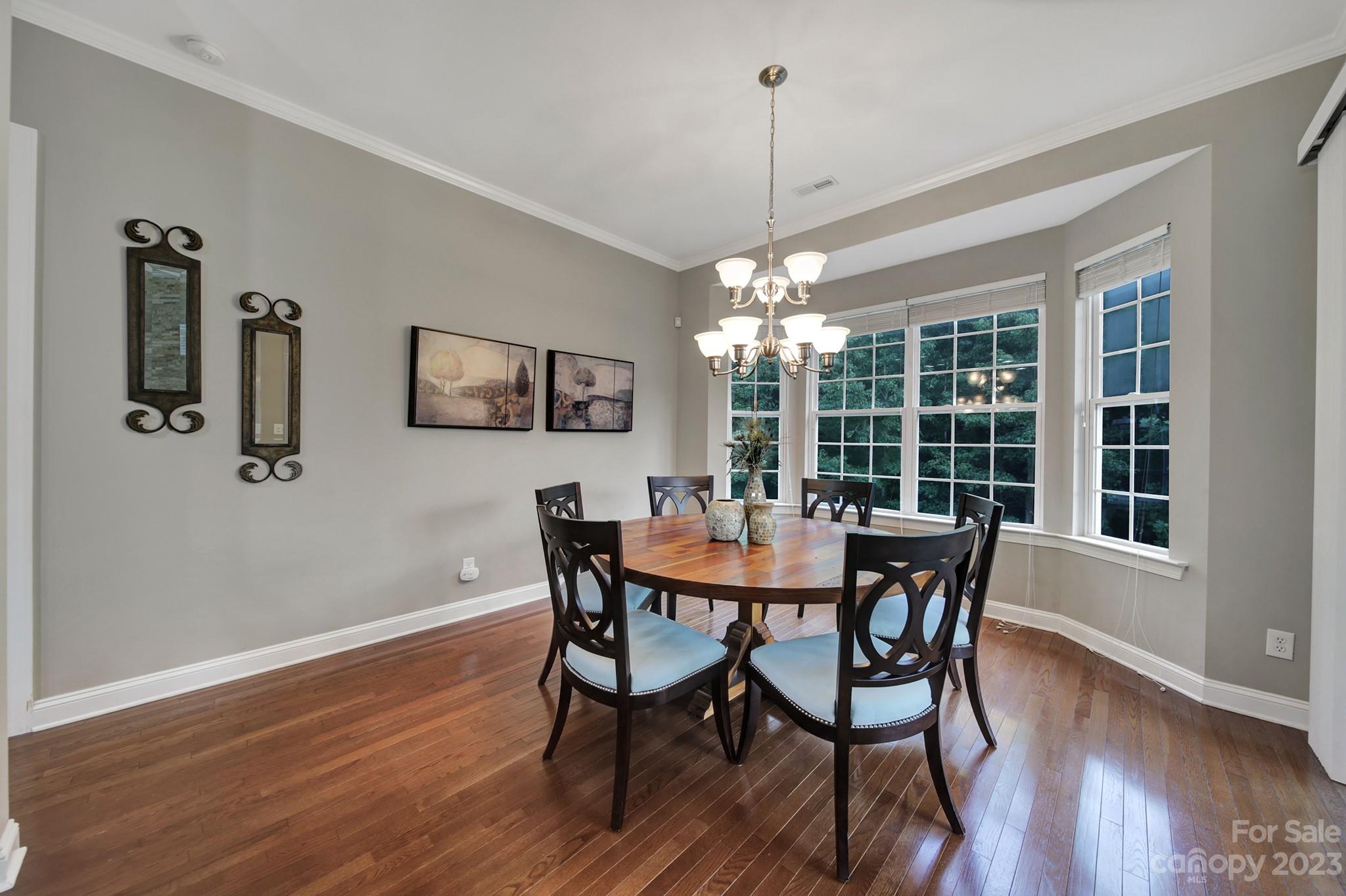 818 Treasure Court Fort Mill, SC 29708 - Photo 10 of 47 a view of a dining room with furniture window and wooden floor