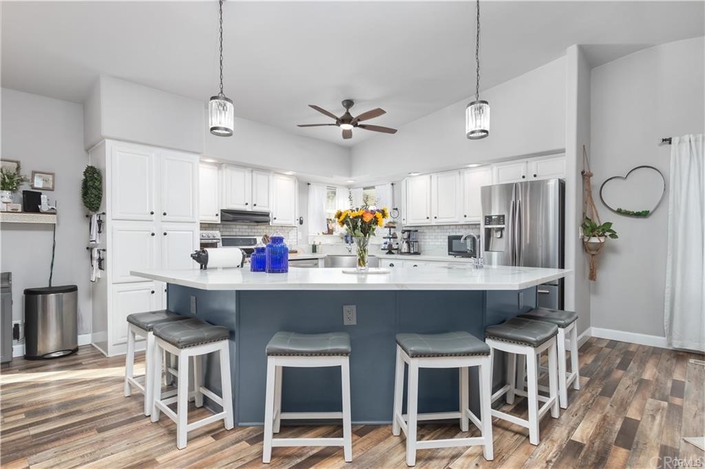 33125 Crown Valley Road Temecula, CA 92592 - Photo 1 of 1 a kitchen with kitchen island granite countertop a sink and a refrigerator