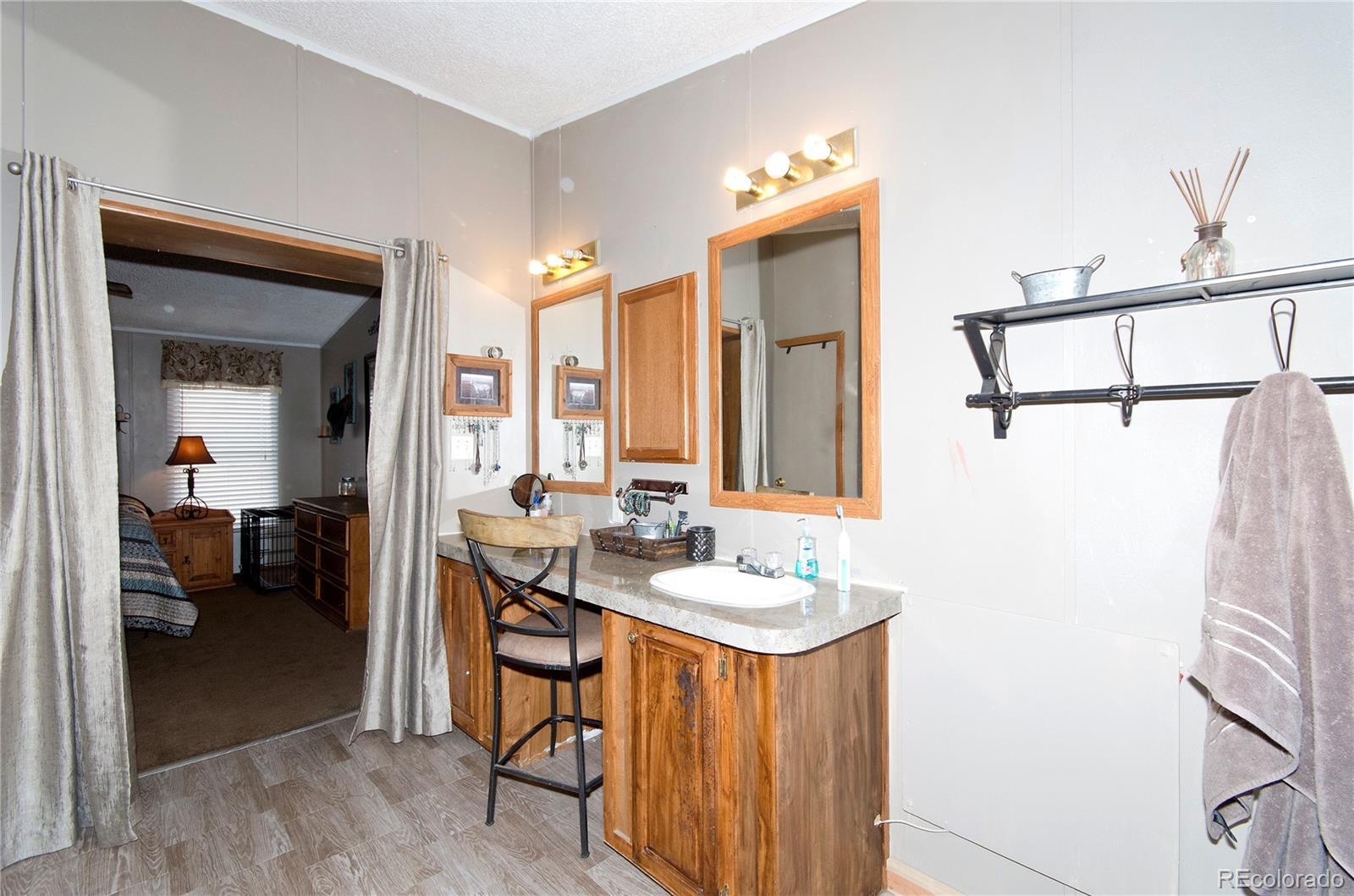 9780 Hahn Road Calhan, CO 80808 - Photo 8 of 24 a bathroom with a sink mirror and a shower