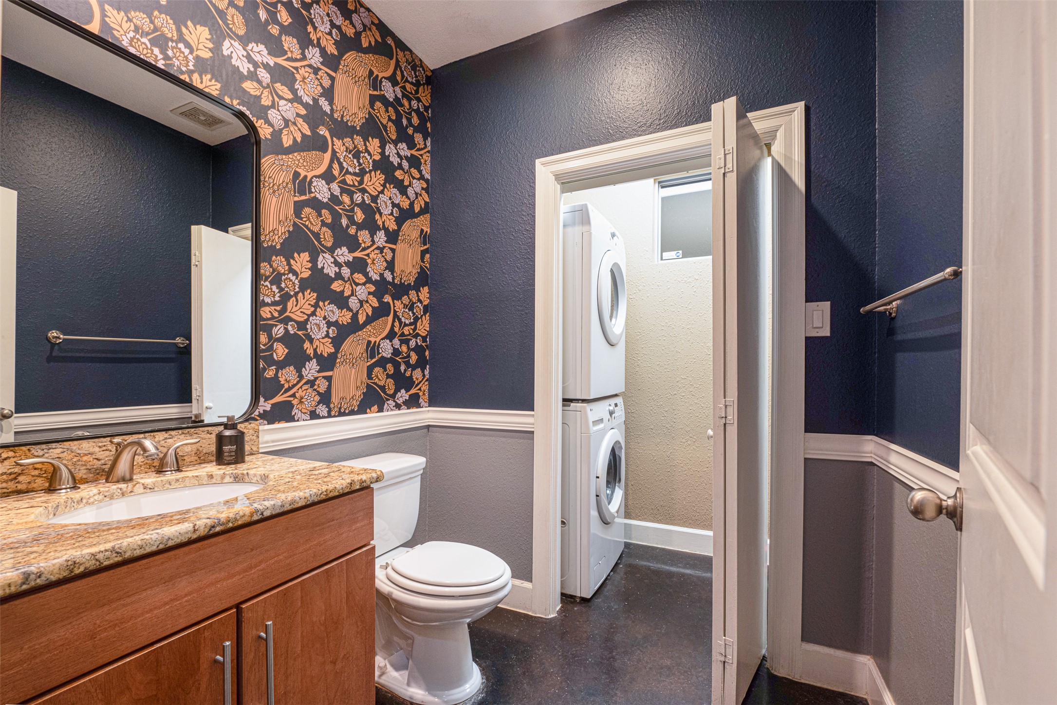 2302 East 9th Street Austin, TX 78702 - Photo 11 of 31 A striking powder room with granite counters and an adjacent laundry area.