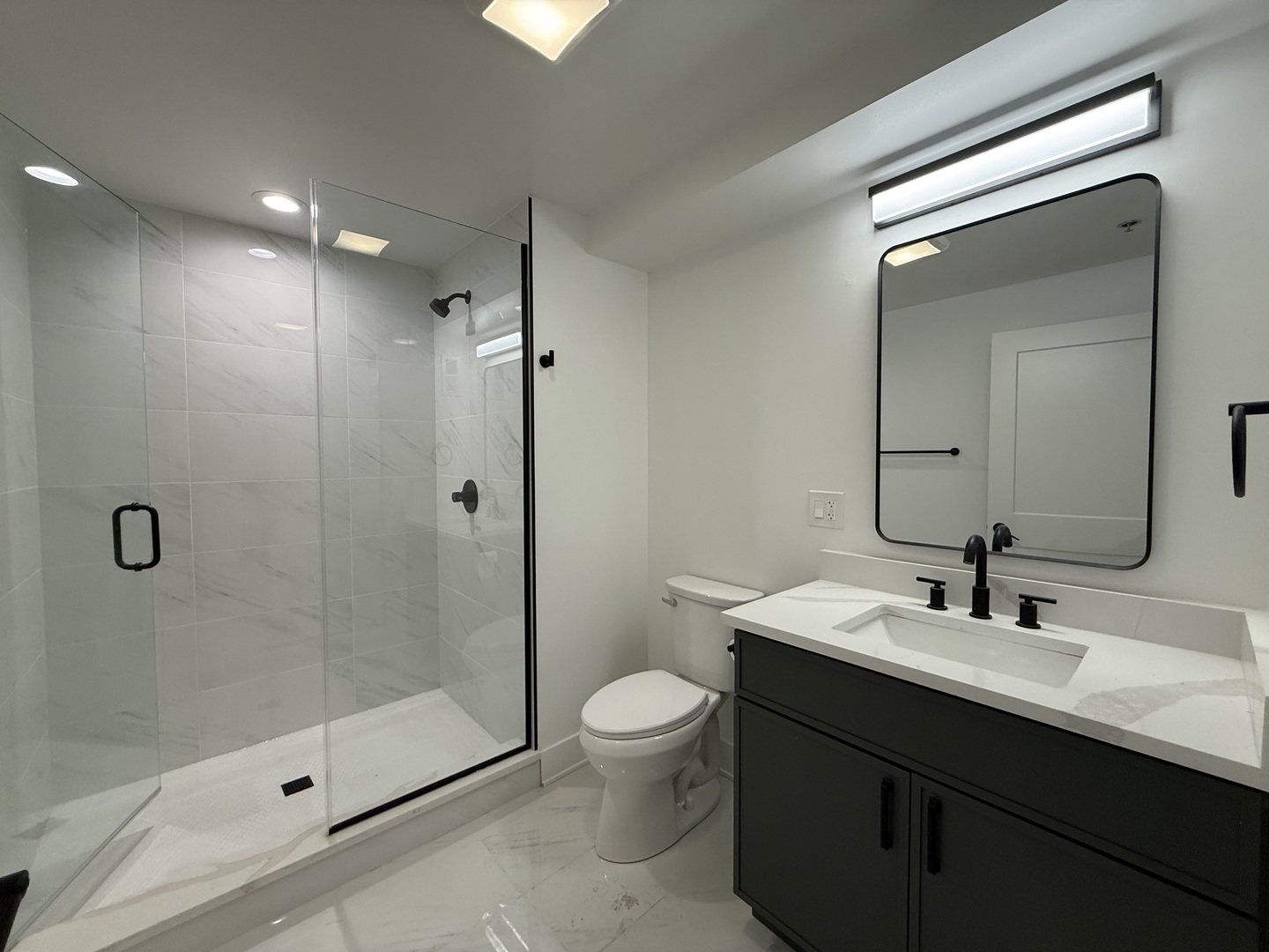 1453 Maple Avenue, Unit B06 Evanston, IL 60201 - Photo 5 of 16 a bathroom with a sink a toilet and shower