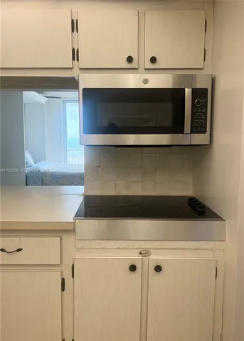 a close view of a stove a microwave and cabinets