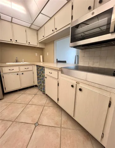 a kitchen with cabinets and appliances