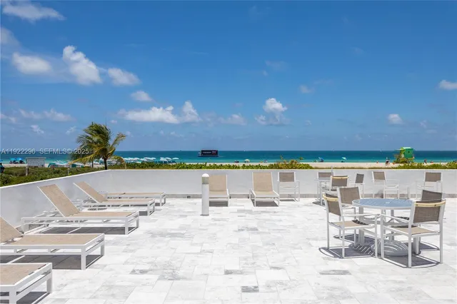 a view of swimming pool with outdoor seating and city view