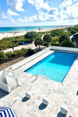 a view of swimming pool with outdoor seating and plants