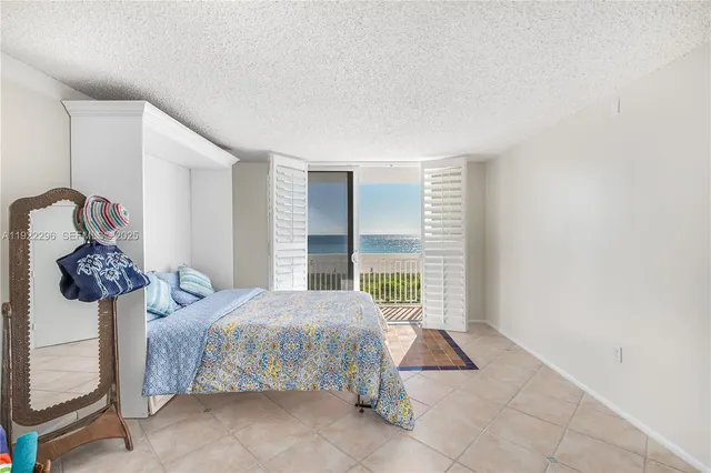 a bedroom with a bed and glass window