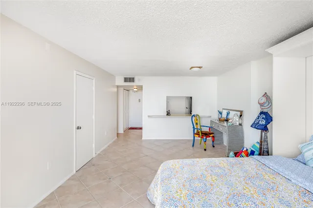 a bedroom with a bed and a tv