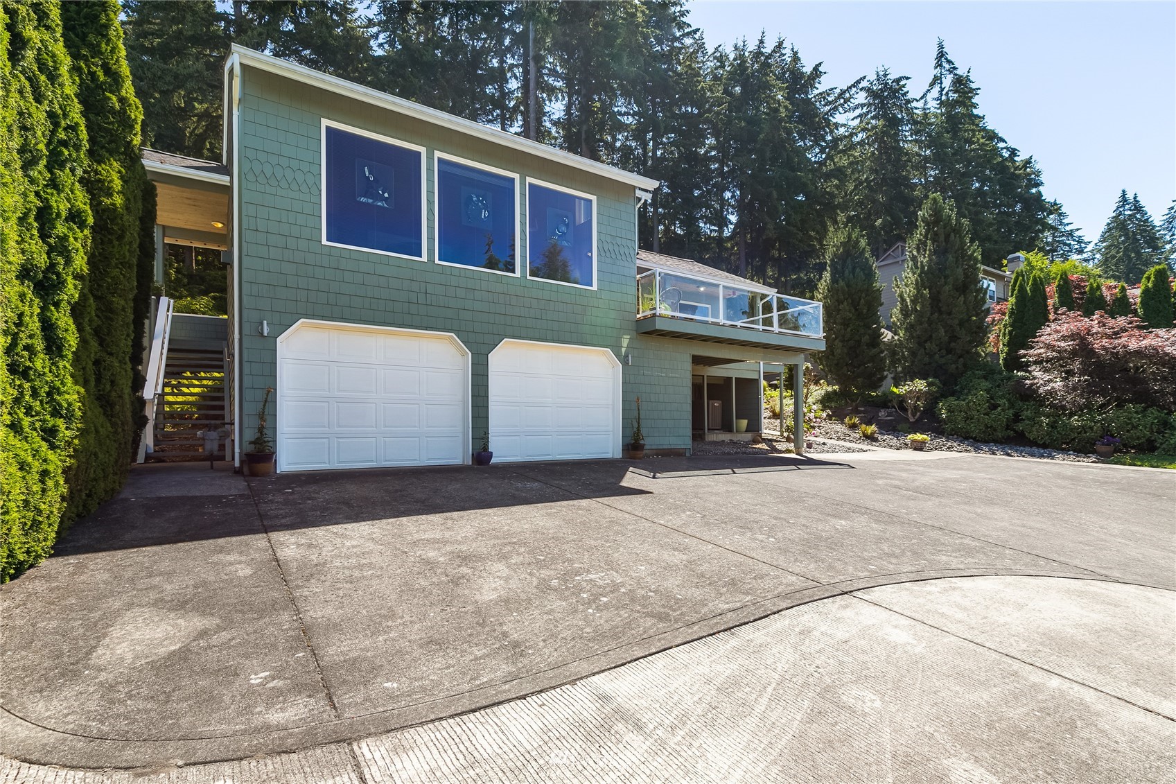1415 37th Street Bellingham, WA 98229 - Photo 4 of 37 a front view of a house with a yard and garage