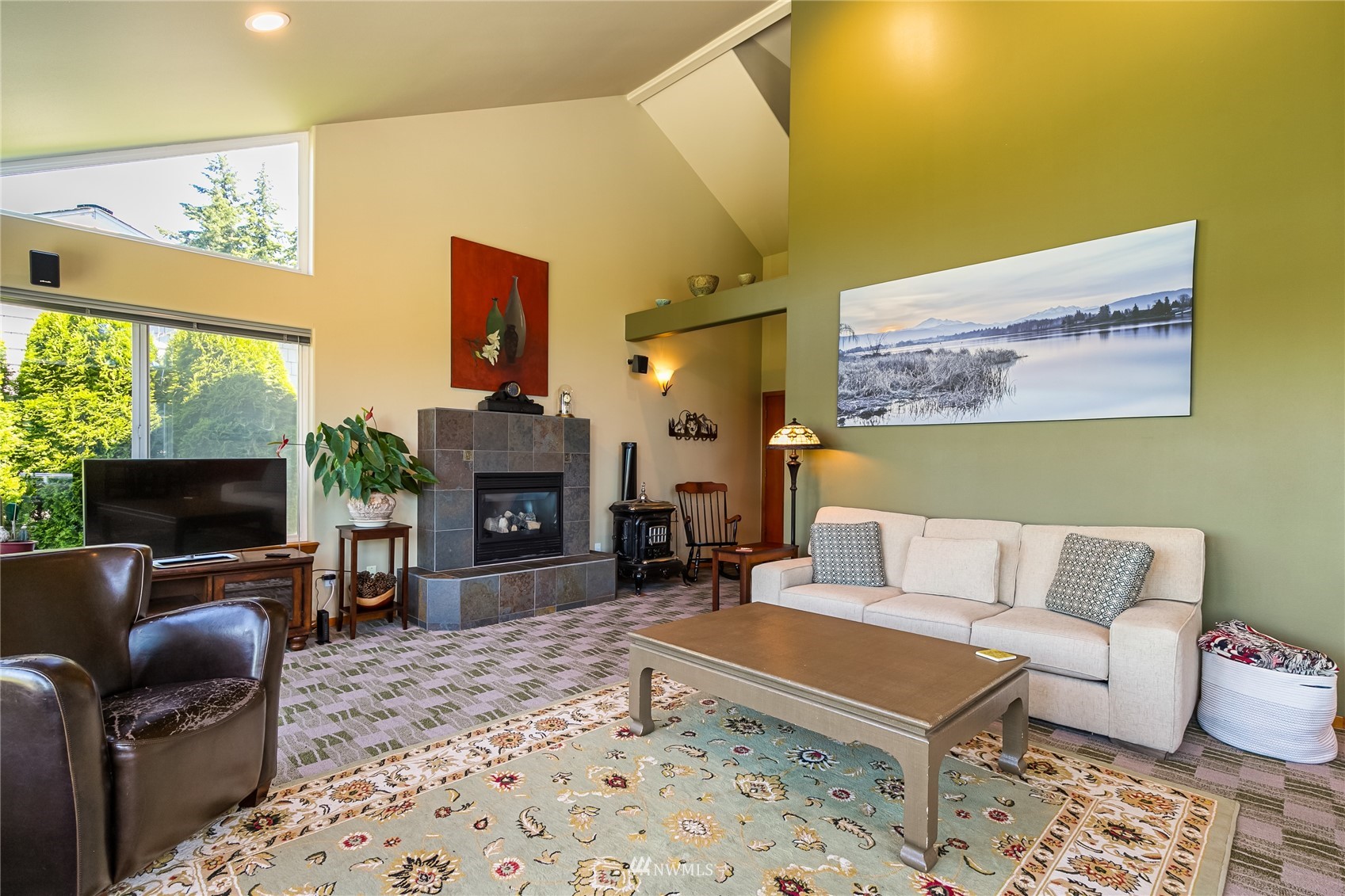 1415 37th Street Bellingham, WA 98229 - Photo 9 of 37 a living room with furniture a flat screen tv and a fireplace